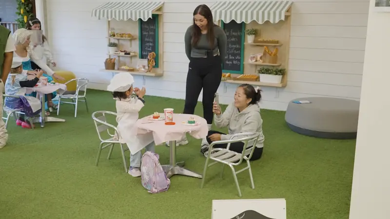 Children and educators at the café tables